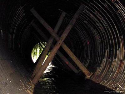 Deformed tunnel with timber pile support.