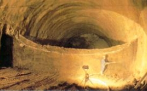 Fig. 6: Shotcreting the tunnel walls with dry mix shotcrete before the next part of the bench is removed